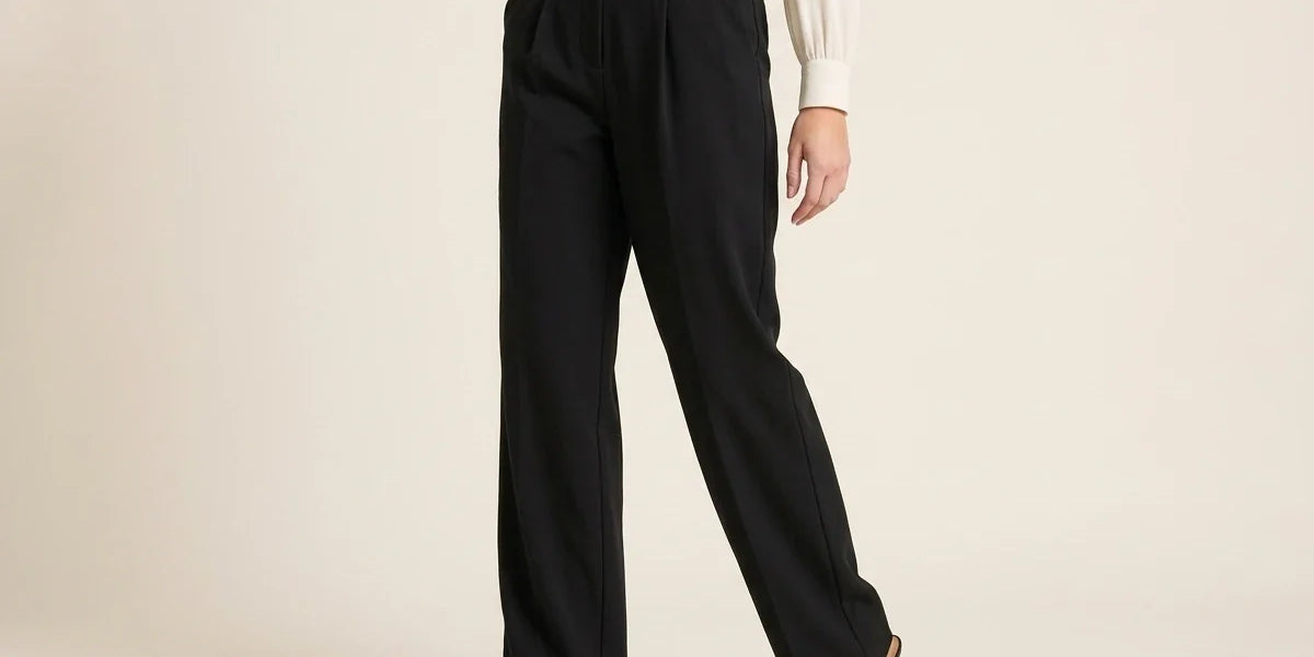 Cropped view of a woman wearing high-waisted pleated black wide-leg trousers paired with pointed-toe slingback heels and a cream blouse.