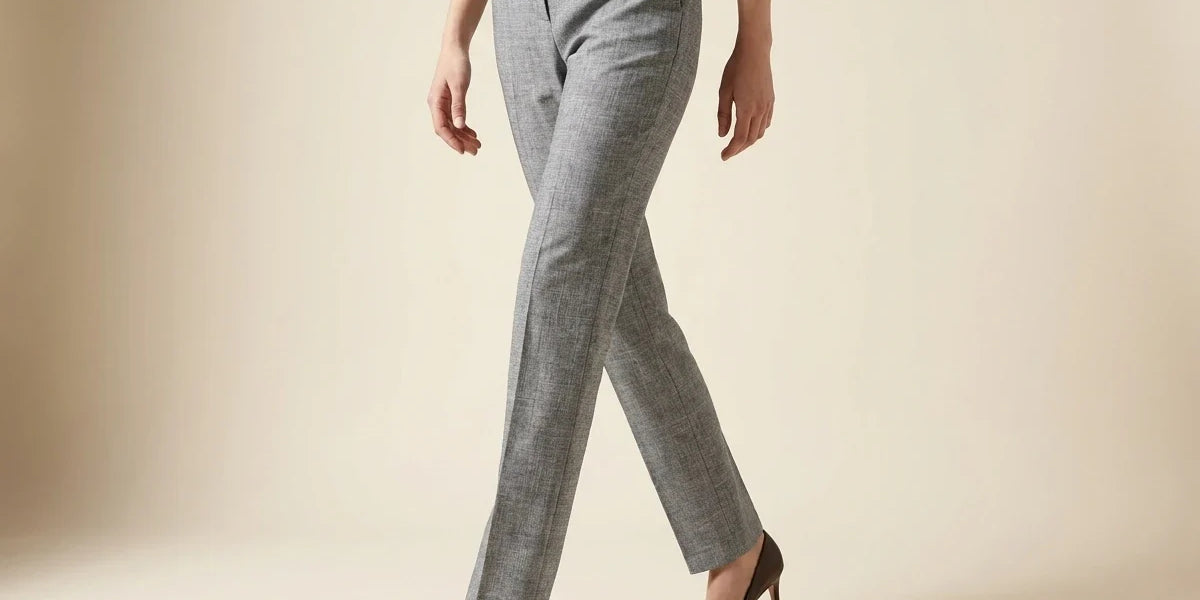 Cropped view of a woman walking in tailored heather grey straight-leg dress trousers paired with dark brown pointed-toe high heels.