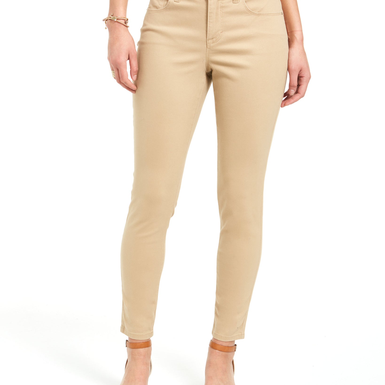 Beige pants worn by a person on a white background