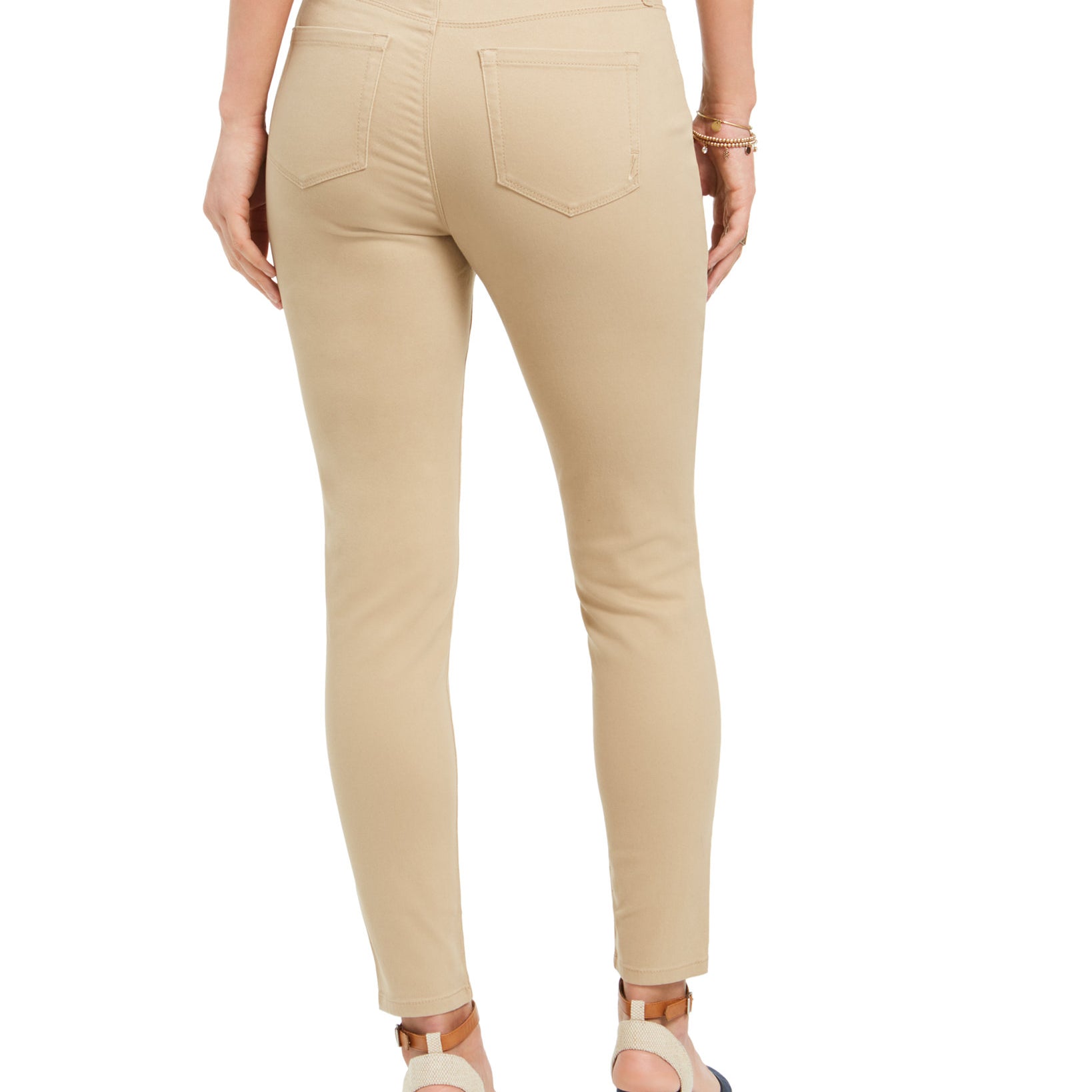 Beige pants worn by a person on a white background
