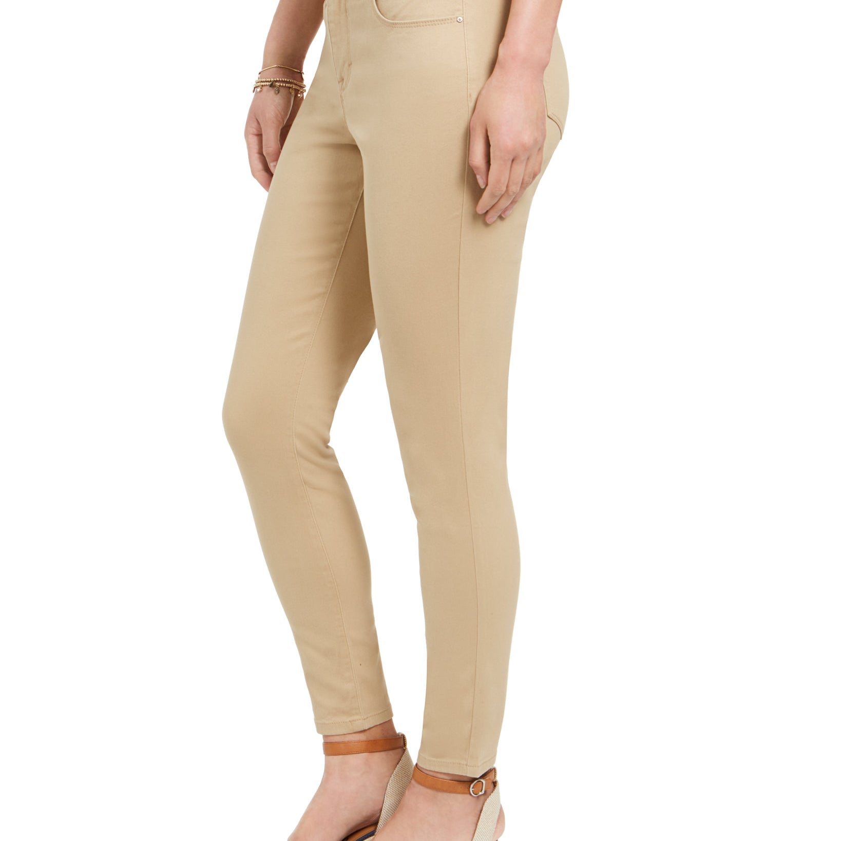 Beige pants worn by a person on a white background