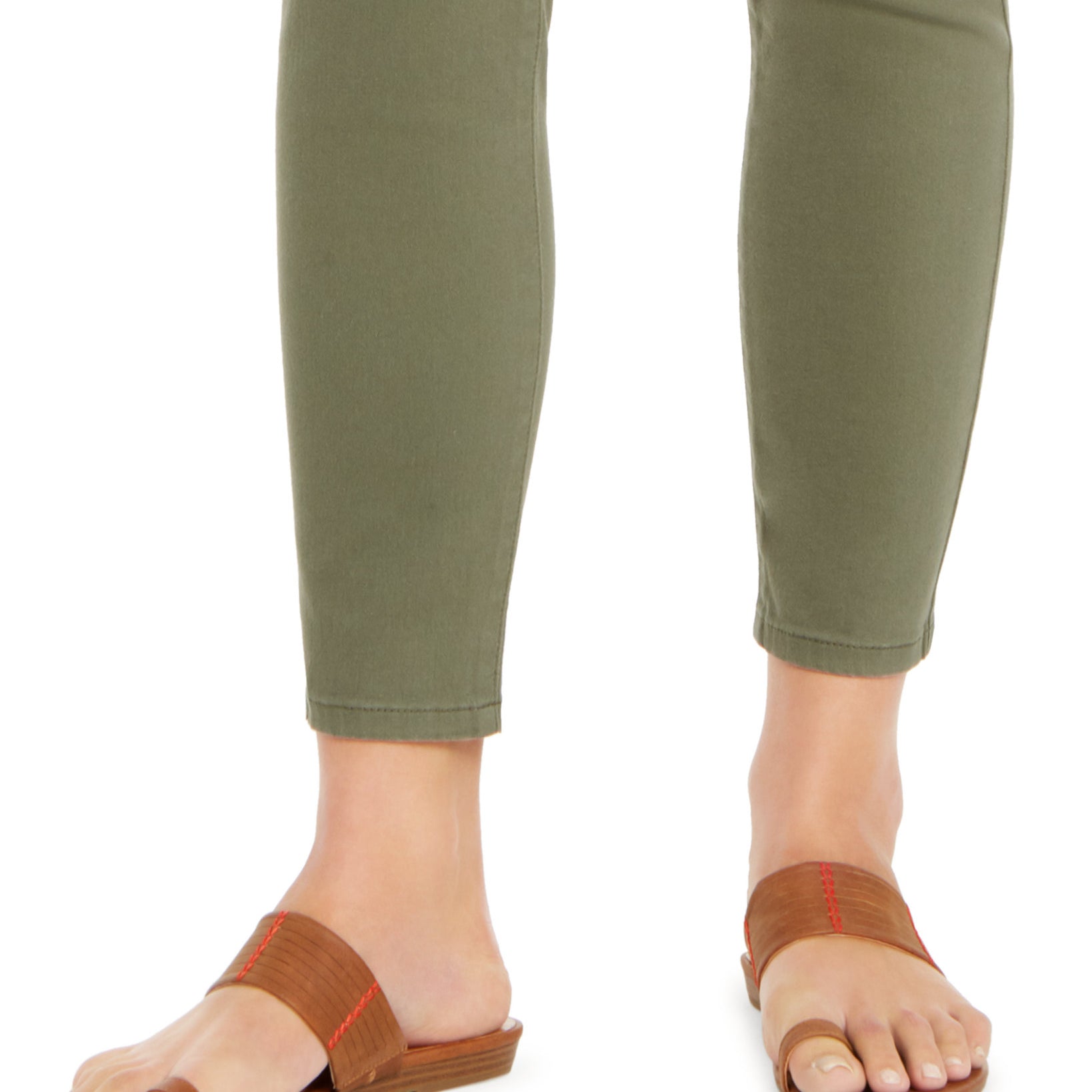 Brown sandals worn with green pants on a white background