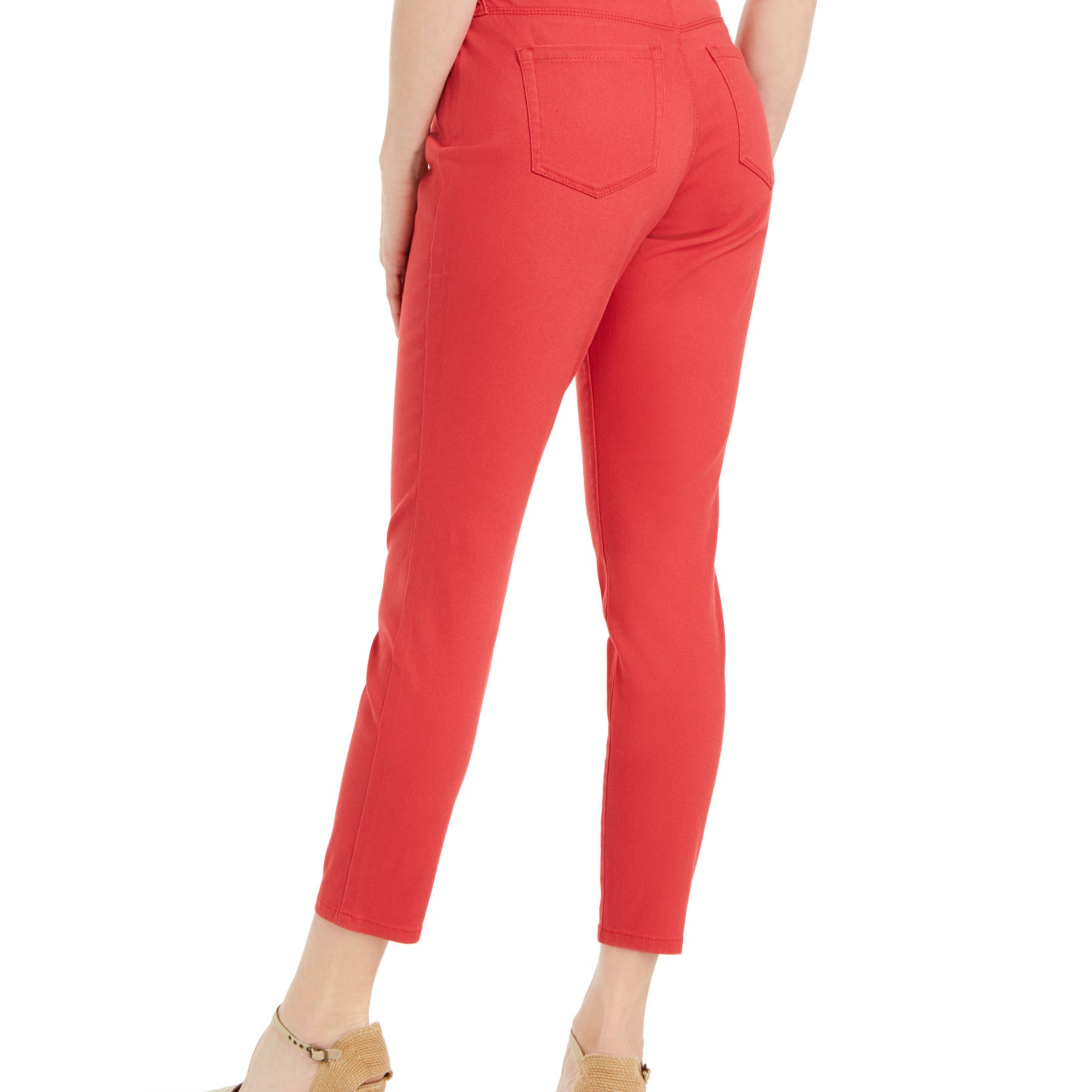 Red pants worn by a person on a white background