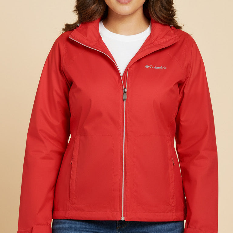 Woman wearing a red jacket with Columbia logo on a beige background