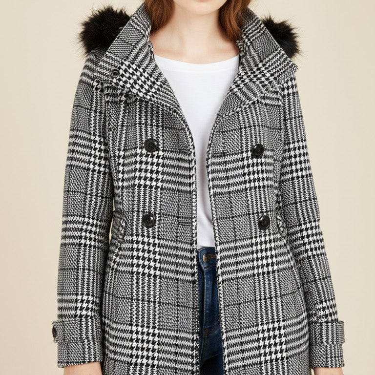 Teen wearing a checkered coat with fur-lined hood on a beige background