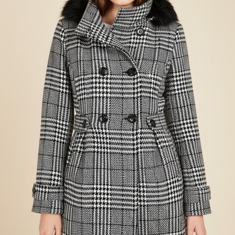 Teen wearing a checkered coat with fur collar on a beige background