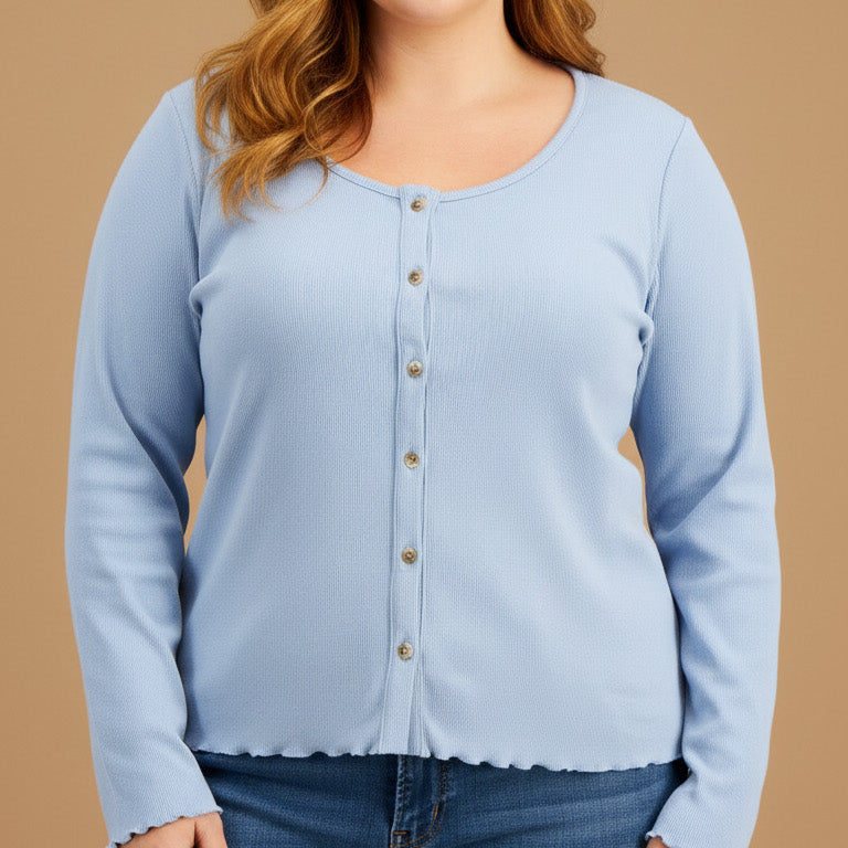 Woman wearing a light blue long-sleeve shirt and jeans on a beige background