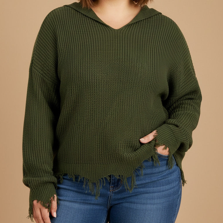 Woman wearing an olive green hoodie and blue jeans on a beige background