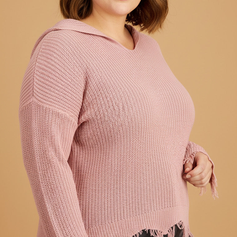 Woman wearing a pink sweater with a beige background