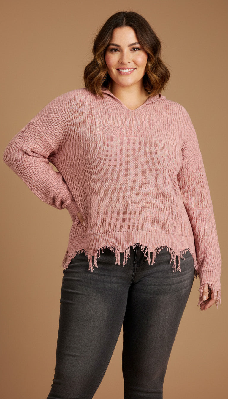 Woman wearing a pink sweater with distressed hem against a beige background
