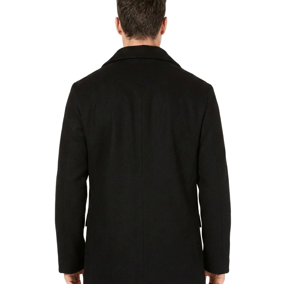 Man wearing a black coat from behind on a white background