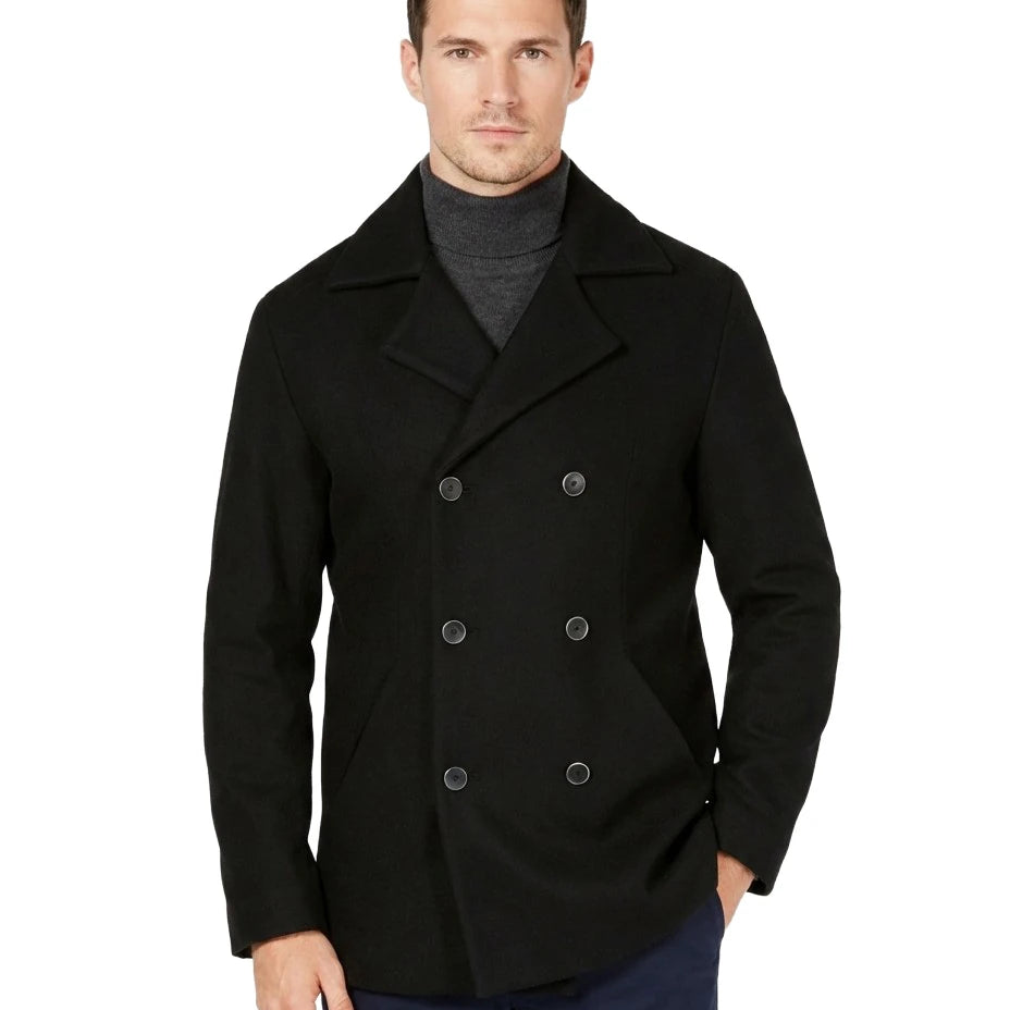 Man wearing a black peacoat on a white background