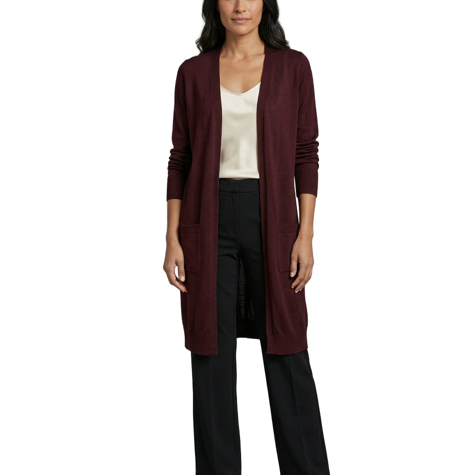 Woman wearing a long burgundy cardigan over a white top and black pants on a white background