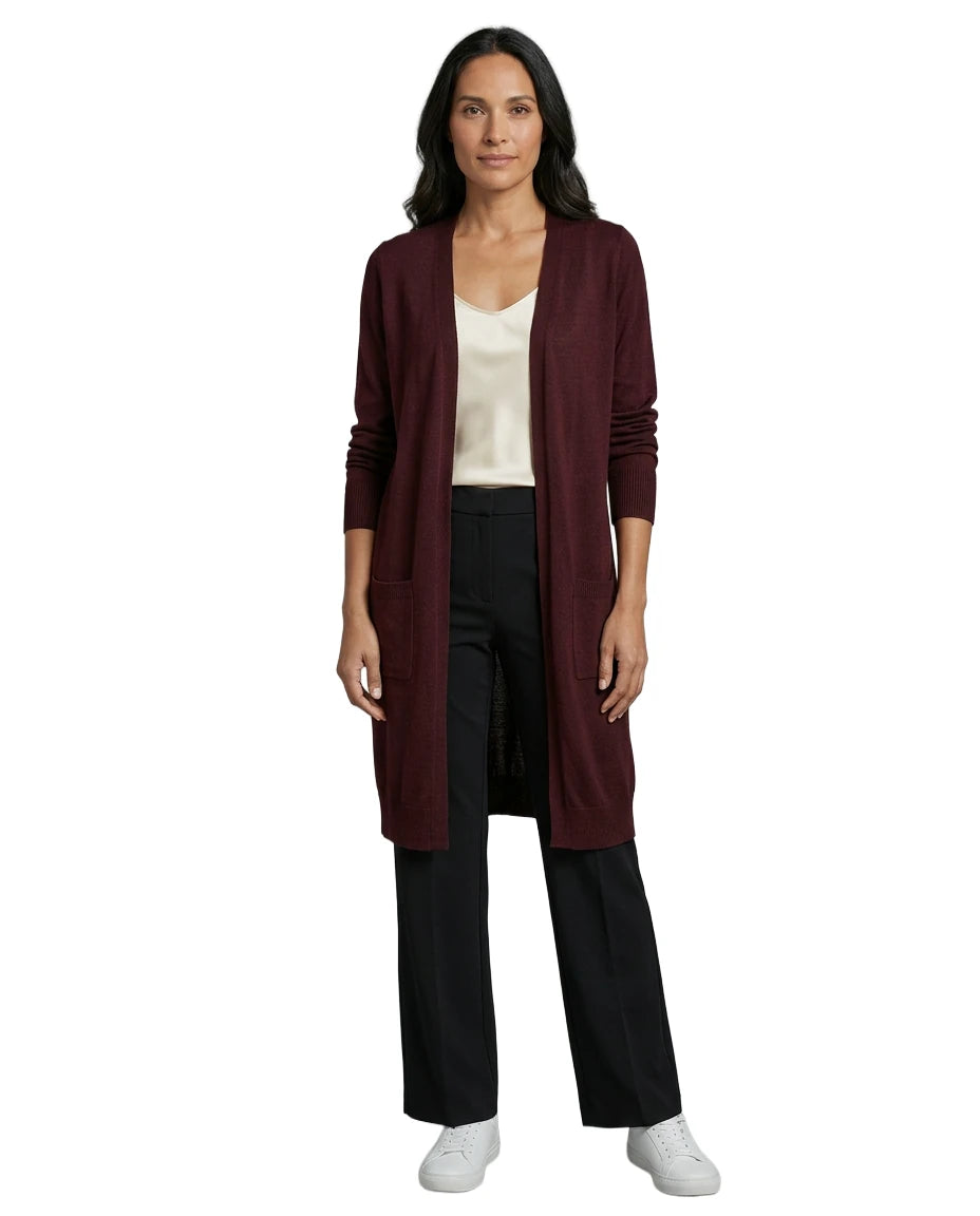 Woman wearing a long burgundy cardigan over a white top and black pants on a white background