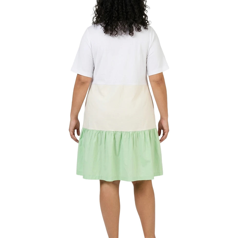 Person wearing a white top and green skirt on a white background