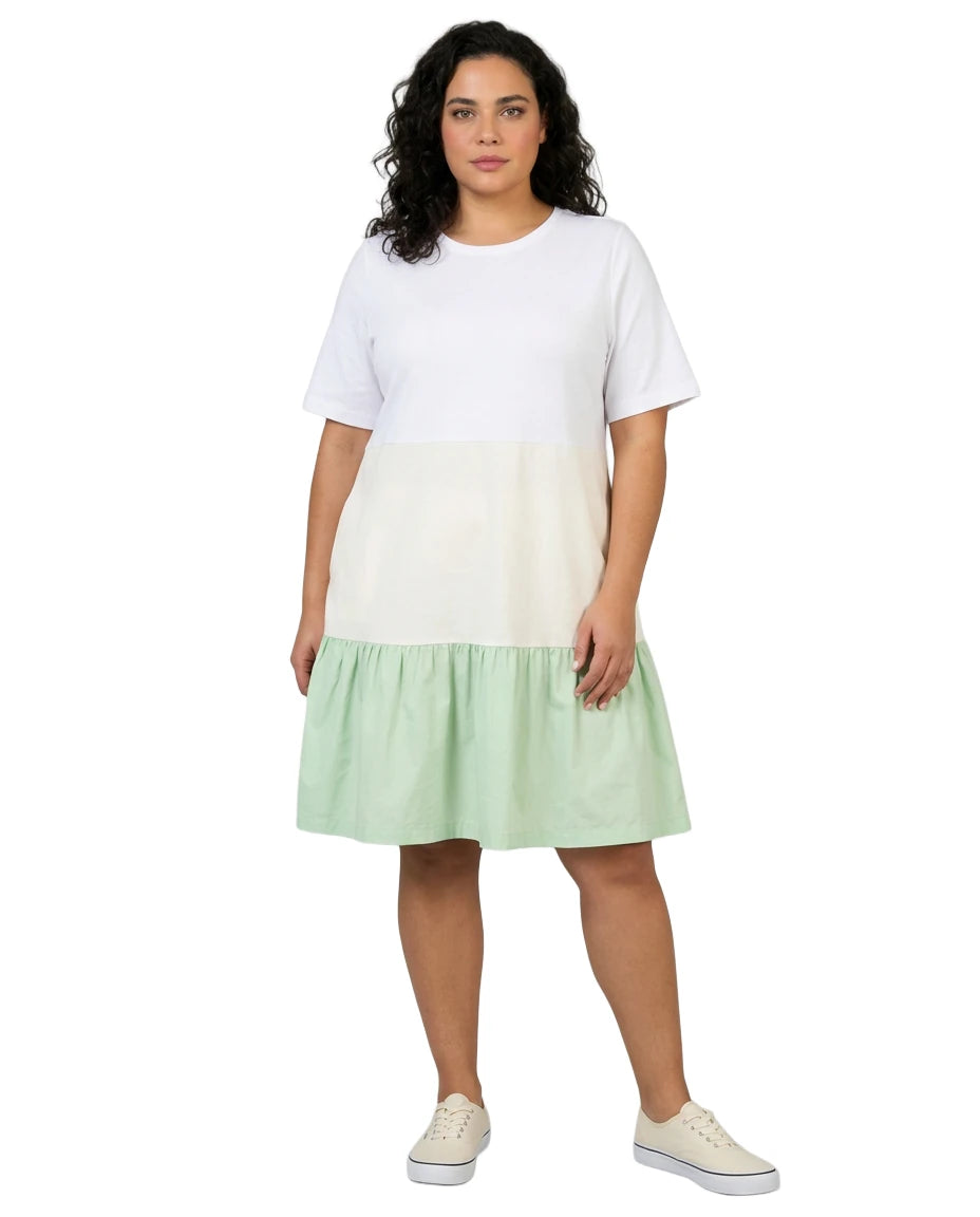 Woman wearing a white and green dress on a white background