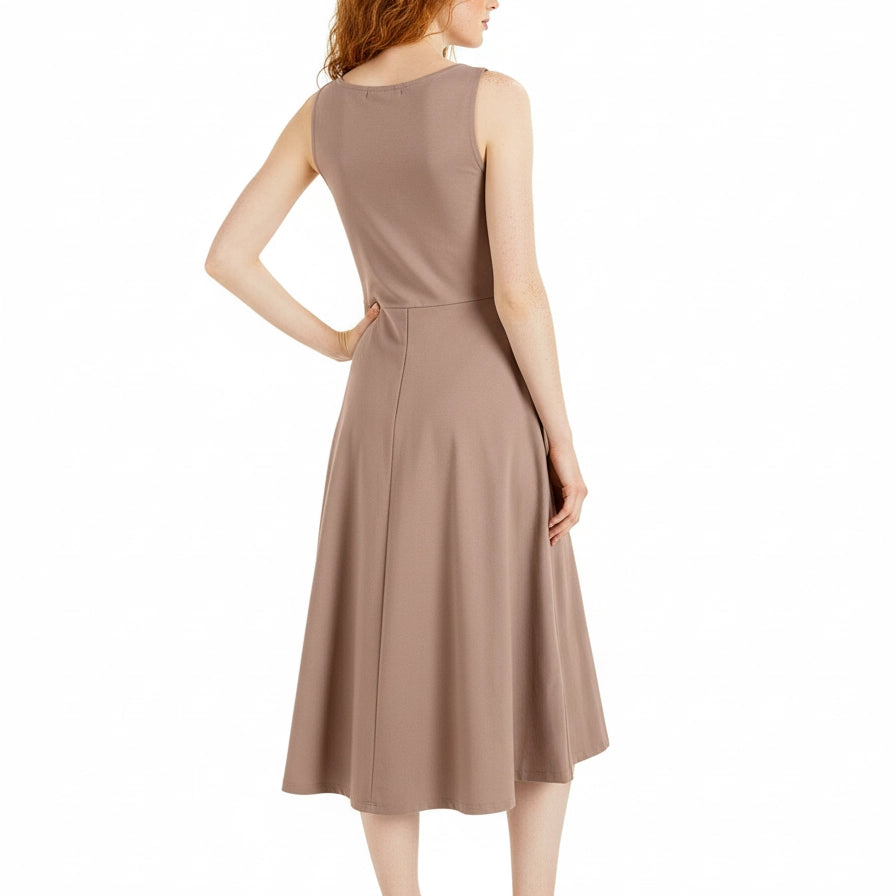 Woman wearing a beige sleeveless dress on a white background