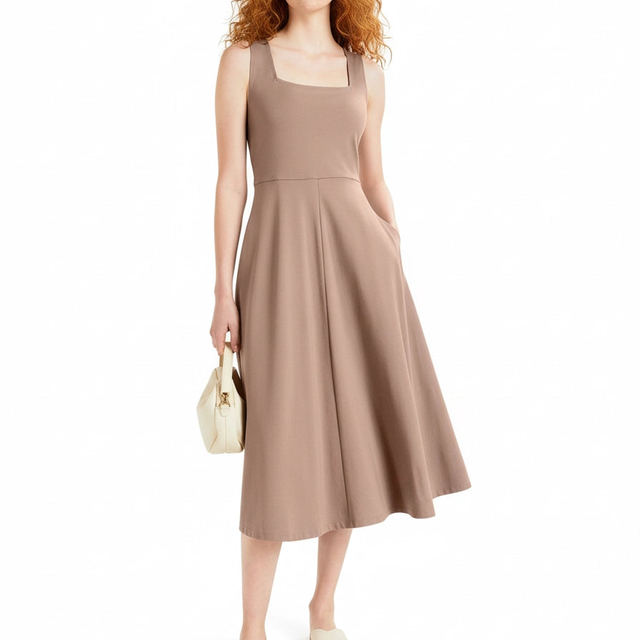 Woman wearing a beige sleeveless dress on a white background