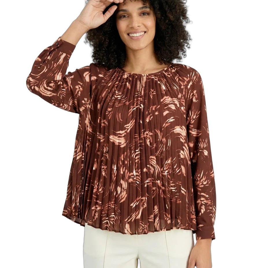 Woman wearing a brown patterned blouse on a white background