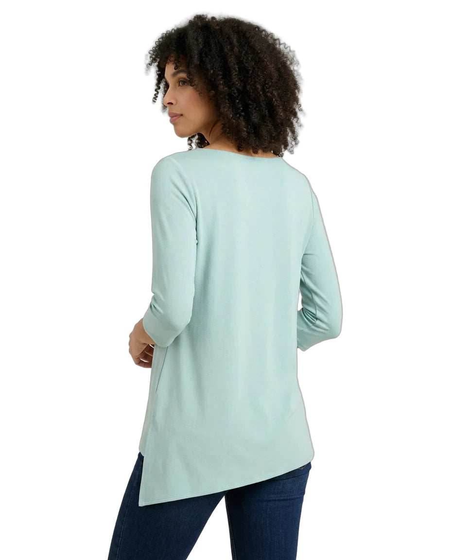 Woman wearing a light blue long-sleeve top on a white background
