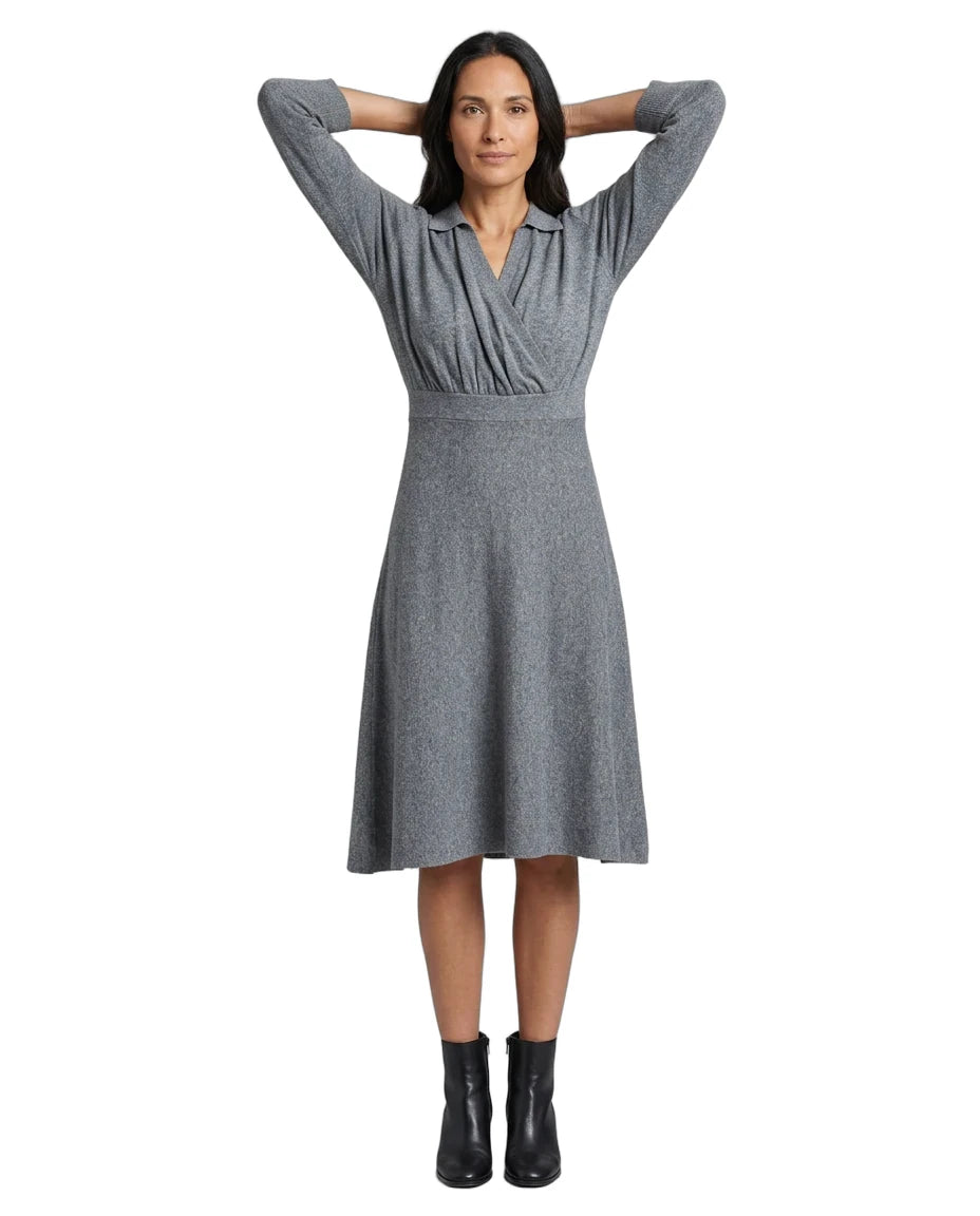 A woman modeling a gray long-sleeve wrap-style dress with a V-neckline and flared skirt, paired with black ankle boots, against a plain white background.
