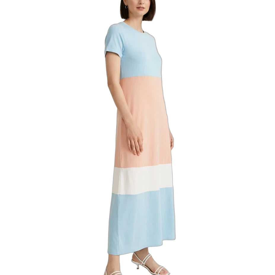 A woman modeling a color-block midi dress with short sleeves, featuring horizontal stripes of light blue, peach, white, and light blue, paired with white strappy sandals on a white background.