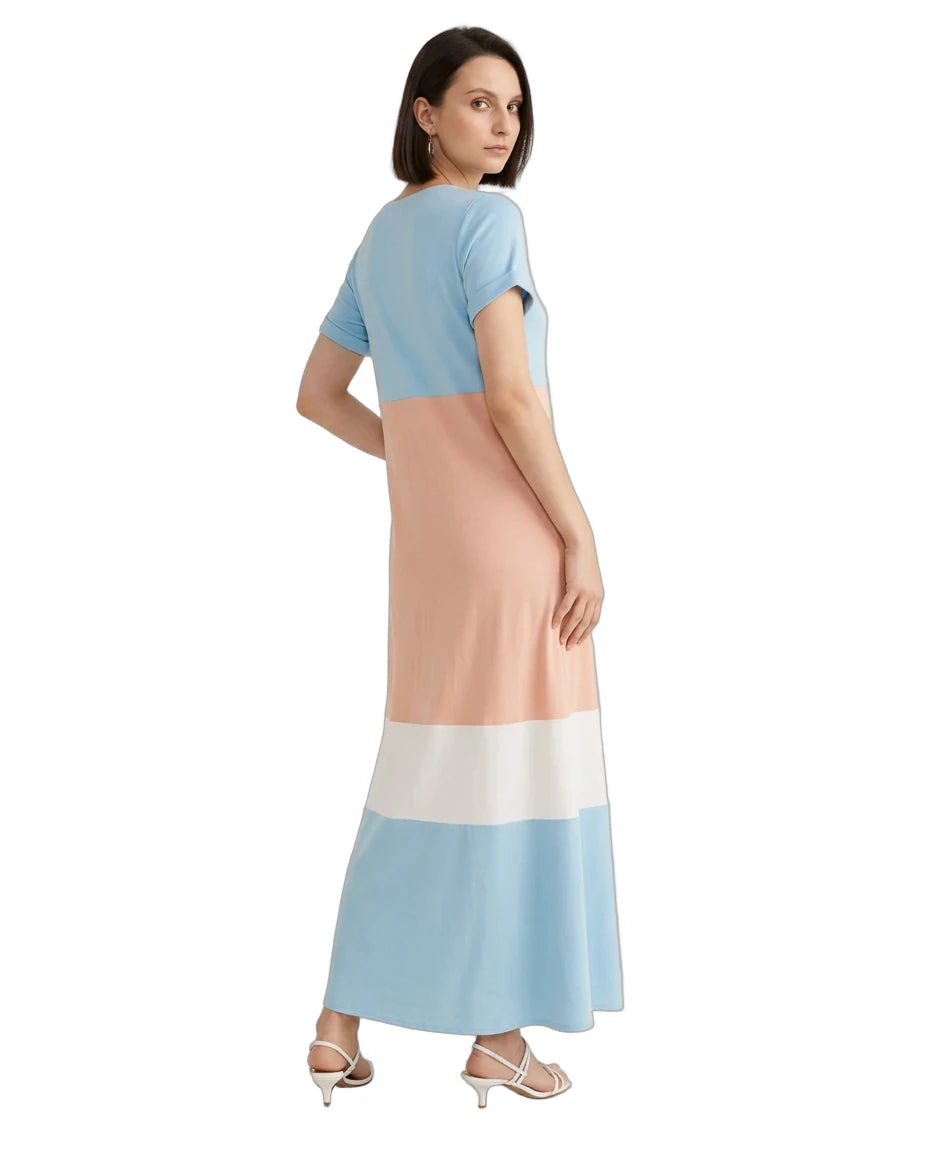 A woman modeling a color-block midi dress with short sleeves, featuring light blue, peach, white, and light blue horizontal color-blocked panels, shown from a rear three-quarter angle on a white background.
