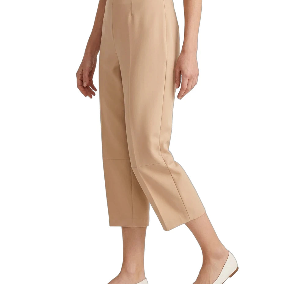 A model wearing beige cropped trousers with a black top and off-white pointed flats, shown from the waist down against a plain white background.