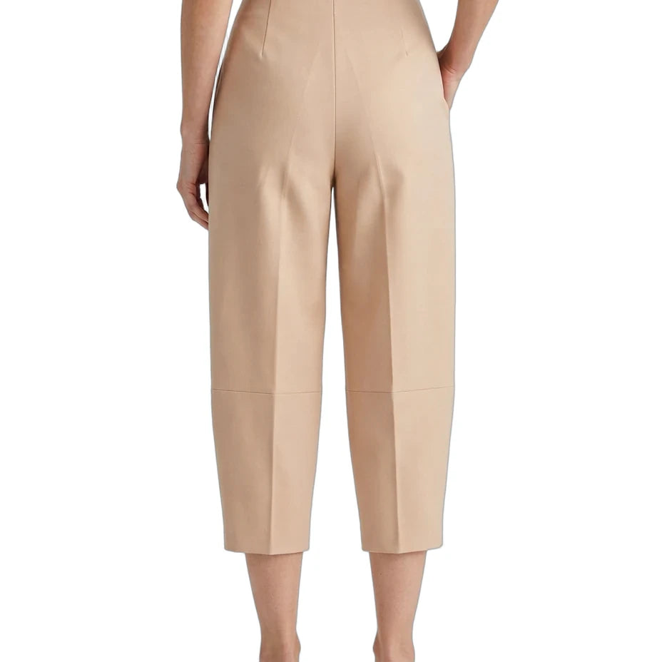 A model shown from the back wearing high-waisted, cropped, wide-leg trousers in a light beige color, paired with a black top and white slip-on shoes, against a plain white background.