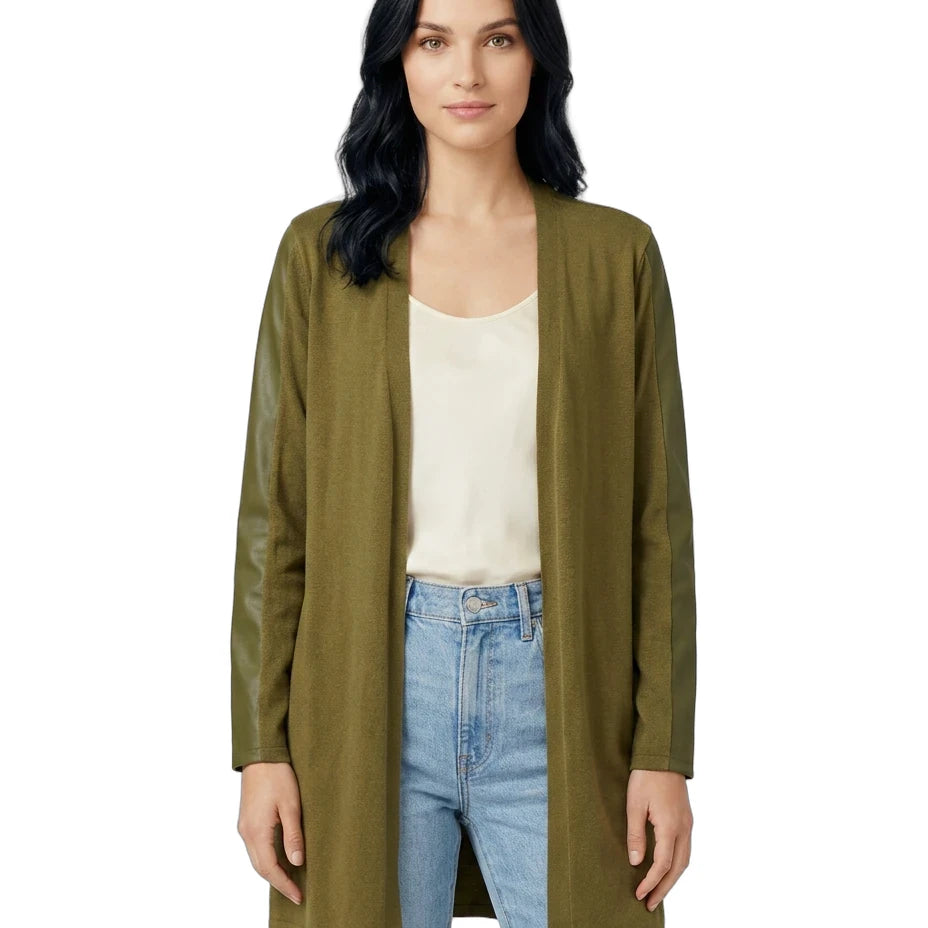 Woman wearing an olive green cardigan over a white shirt and blue jeans on a white background