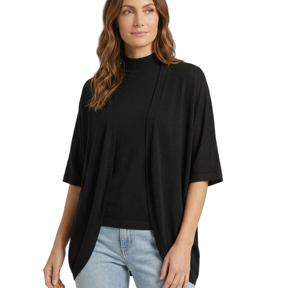 Woman wearing a black top and light blue jeans on a white background