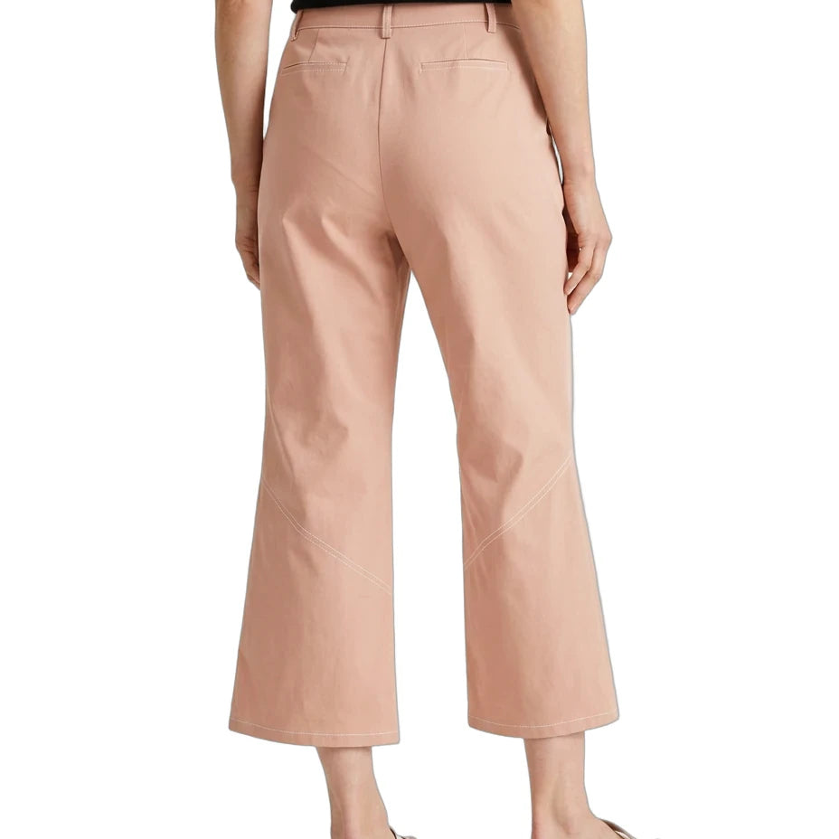 A model shown from the back wearing high-waisted, cropped wide-leg trousers in a dusty peach-pink color, paired with a black top and white slide sandals, against a plain white background.