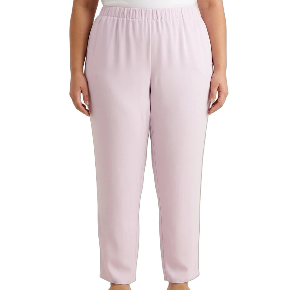 A model wearing light pink wide-leg cropped pants with an elastic waistband, paired with a white top and tan shoes, shown against a plain white background.