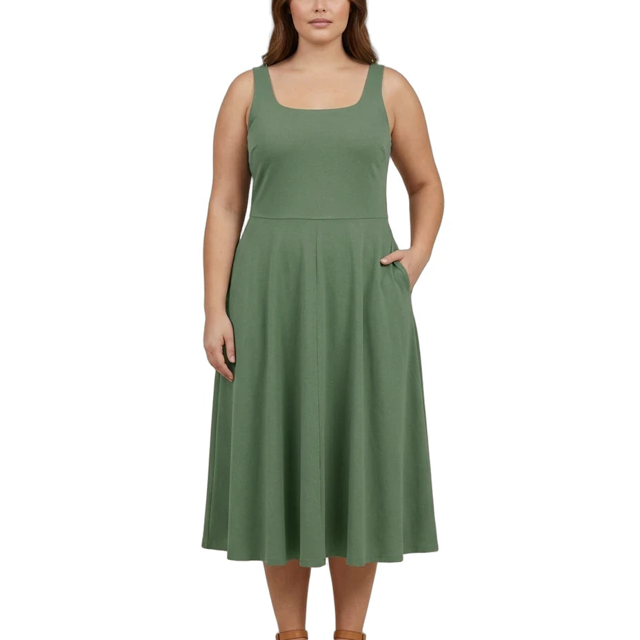 A woman modeling a sleeveless sage green midi dress with a square neckline, fitted waist, and flared skirt with side pockets, paired with tan sandals on a white background.