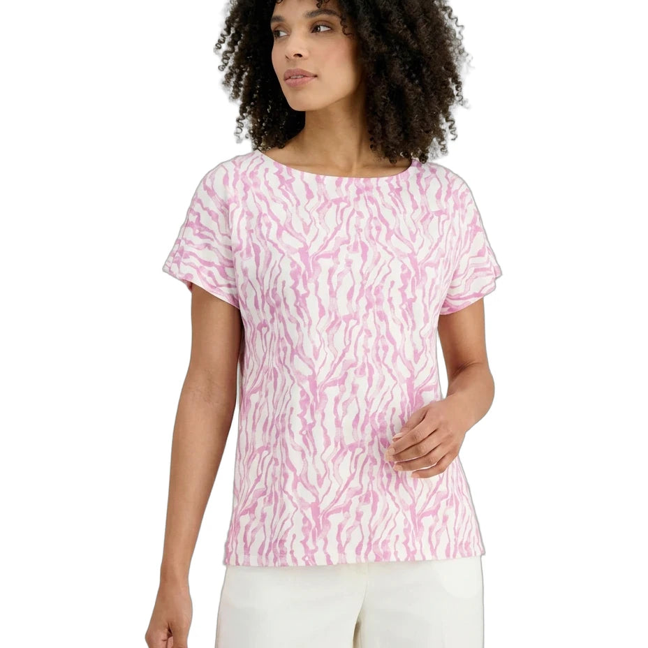 Woman wearing a pink patterned shirt on a white background