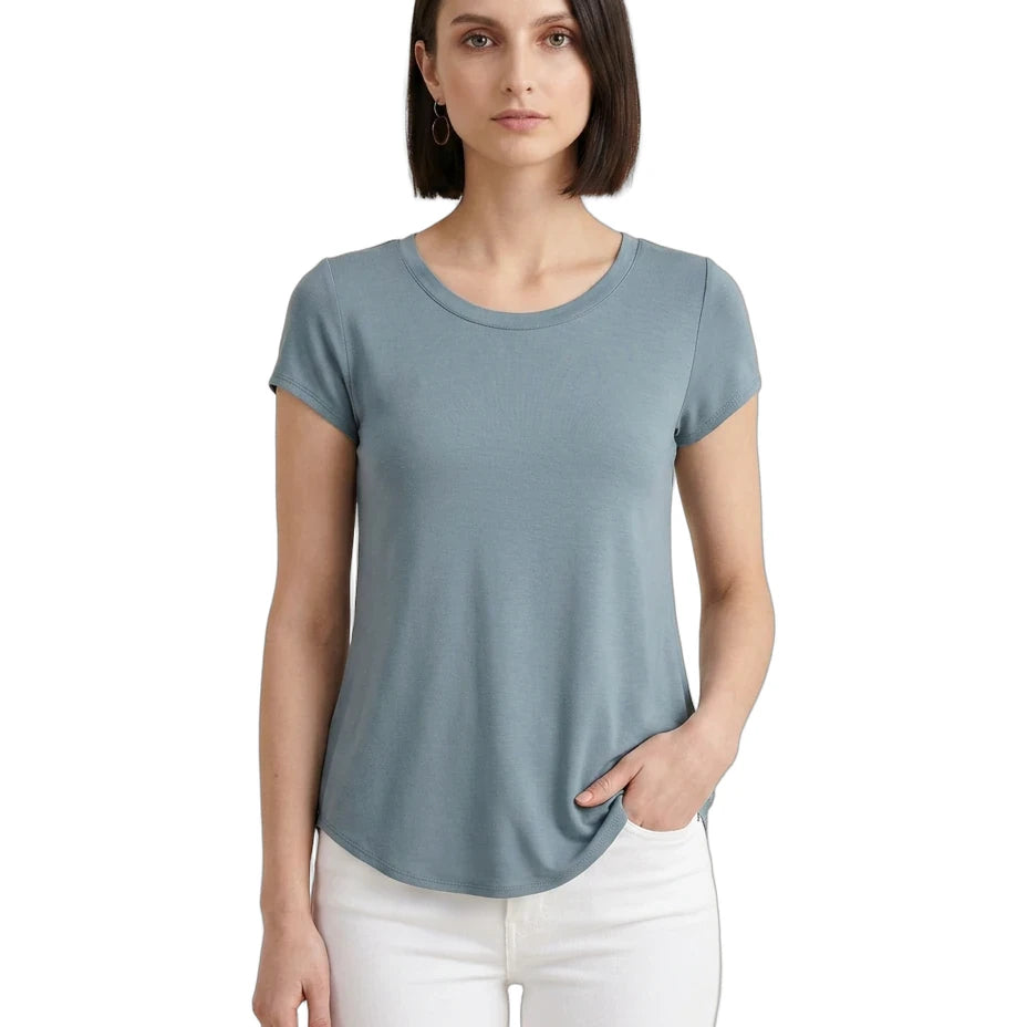 Woman wearing a light blue t-shirt and white pants on a white background