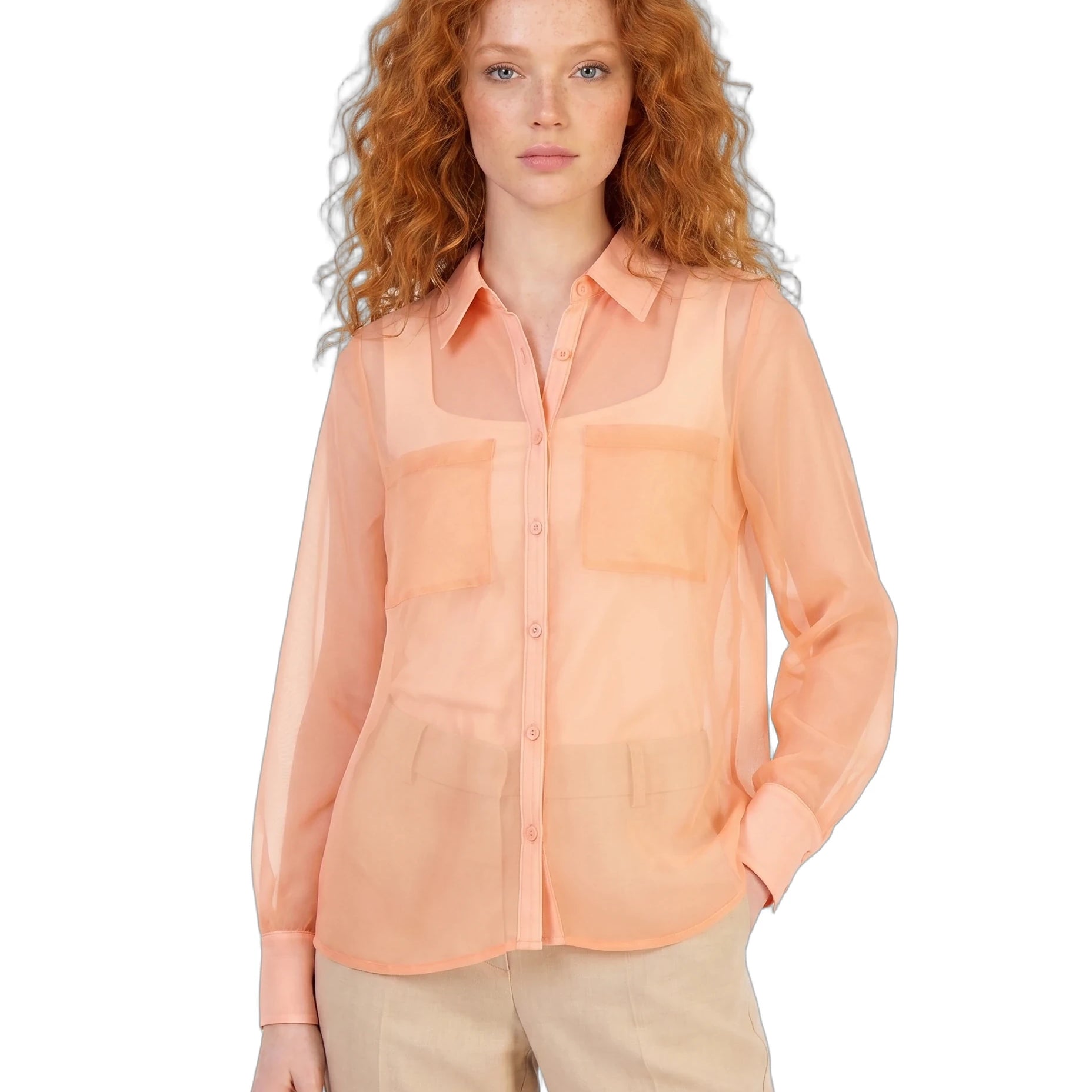 Woman wearing a peach sheer blouse on a white background