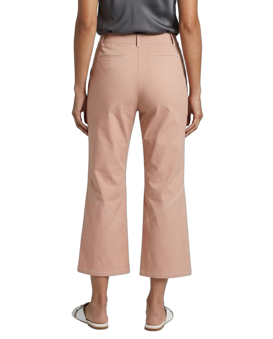 A model shown from the back wearing dusty rose cropped trousers, a dark gray top, and white slide sandals against a plain white background.