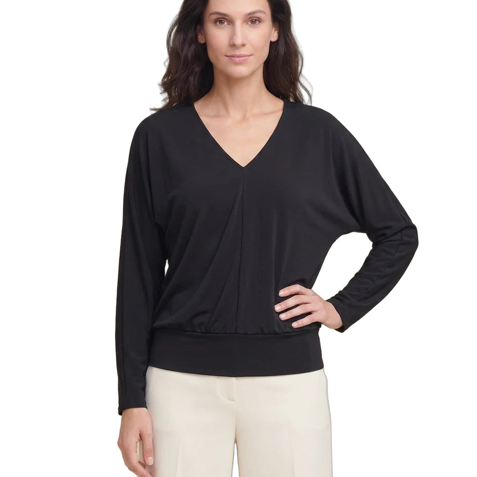 Woman wearing a black long-sleeve top on a white background