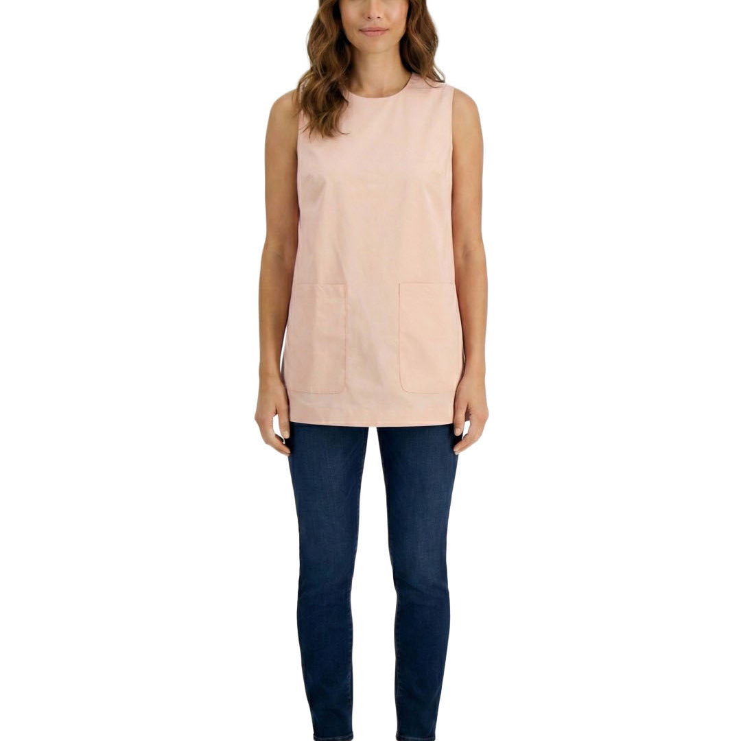 Woman wearing a light pink sleeveless top and dark blue jeans on a white background