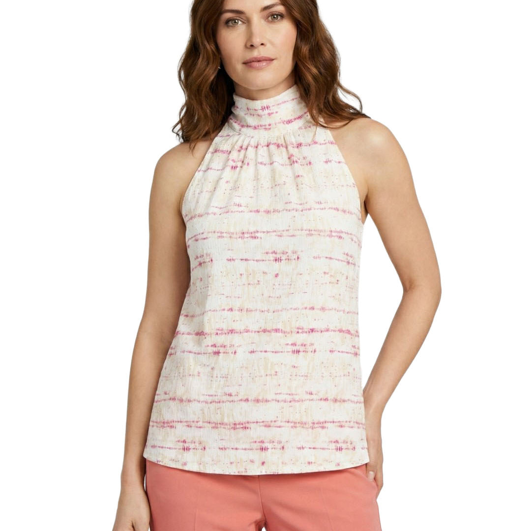 Woman wearing a sleeveless patterned top and pink pants on a white background