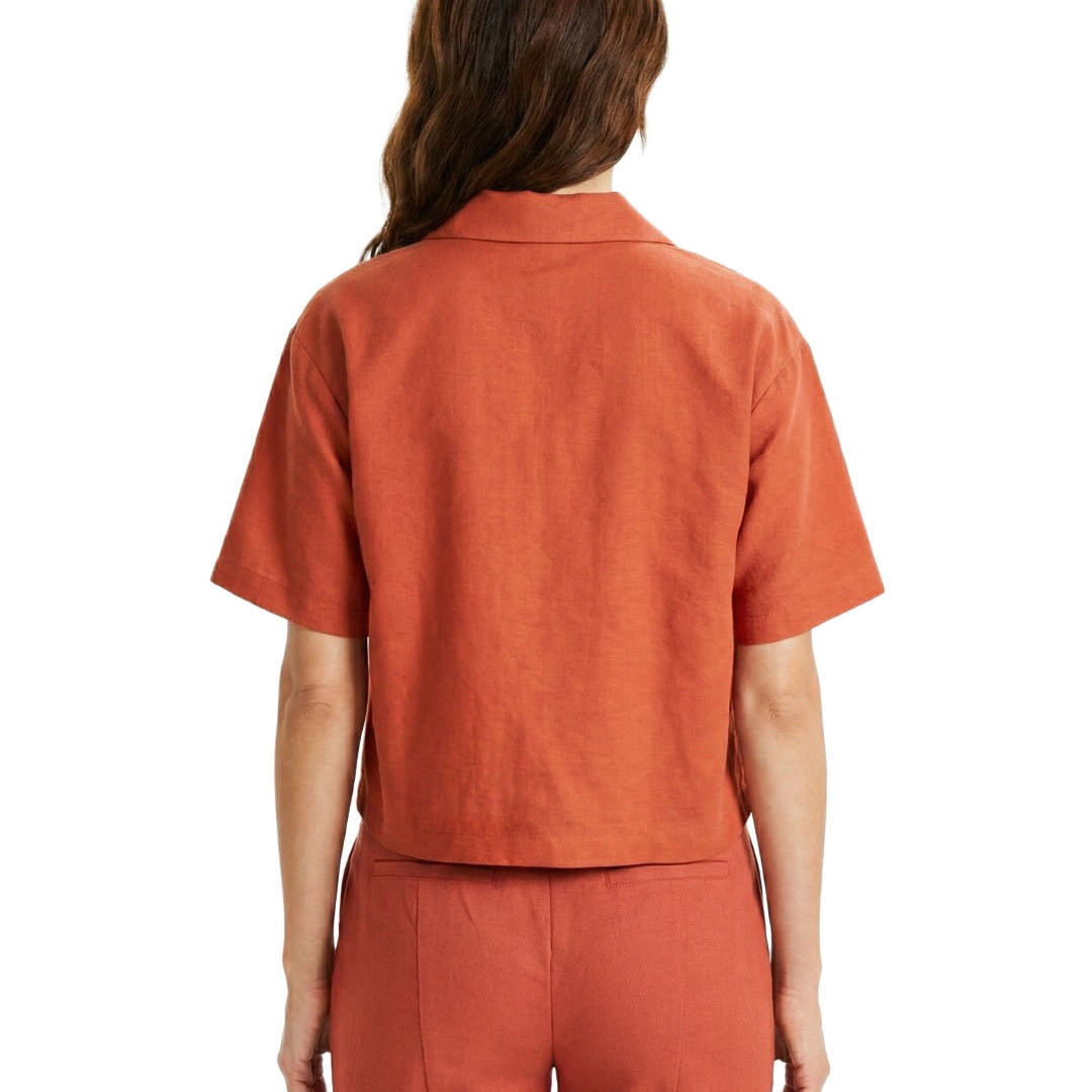 Person wearing an orange shirt and pants on a white background