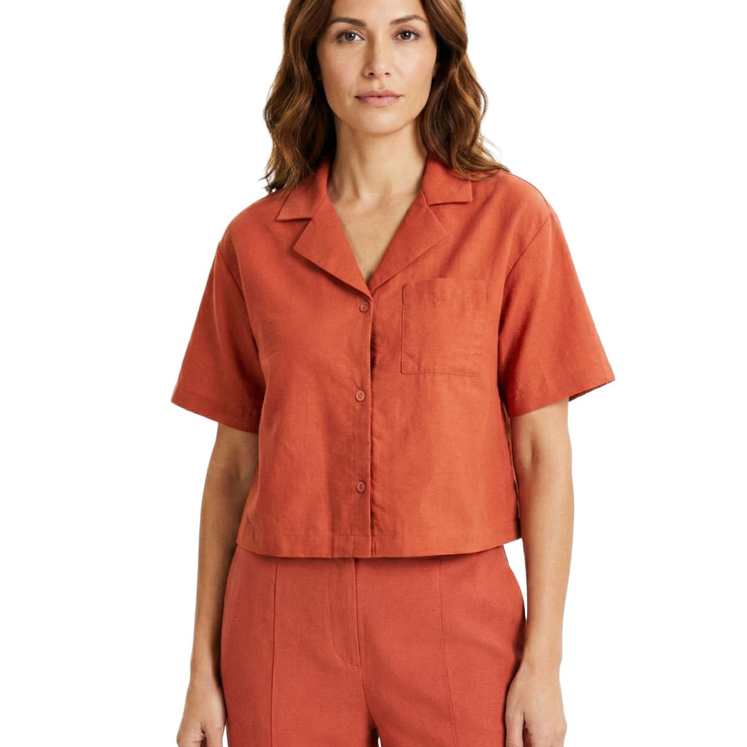 Woman wearing an orange short-sleeve shirt and pants on a white background