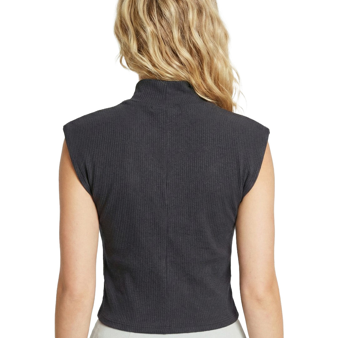 Person wearing a dark gray sleeveless top on a white background