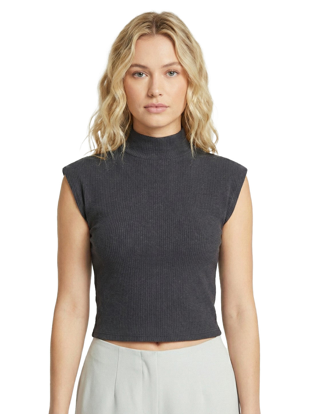 Woman wearing a dark gray sleeveless ribbed top on a white background