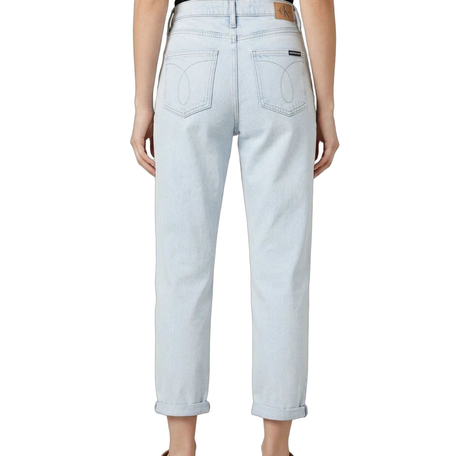 Light blue Calvin Klein jeans worn by a person on a white background