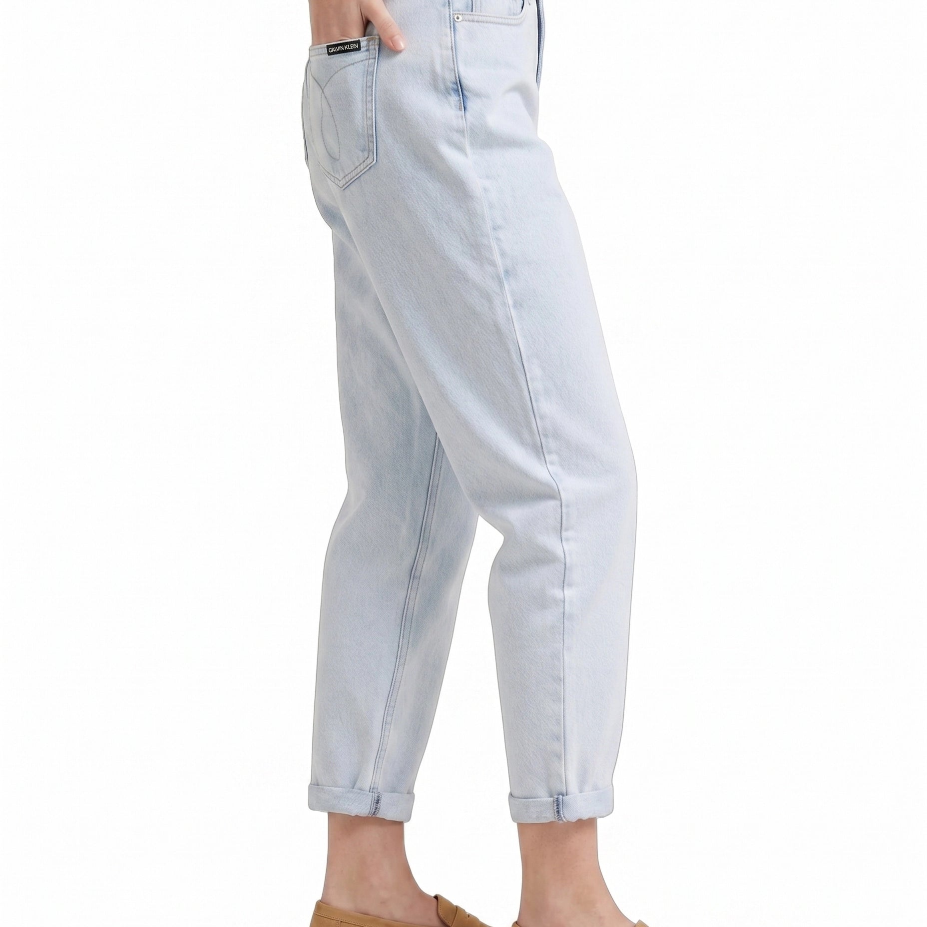 Light blue Calvin Klein jeans worn by a person on a white background