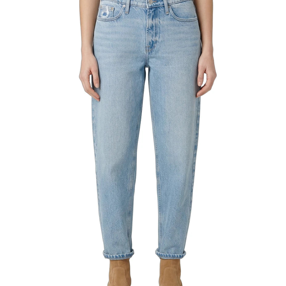 Light Calvin Klein blue jeans worn by a person on a white background