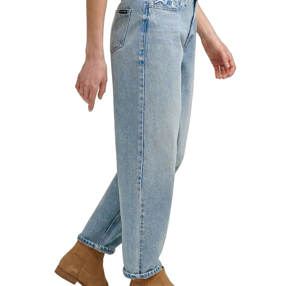 Light Calvin Klein blue jeans worn by a person on a white background