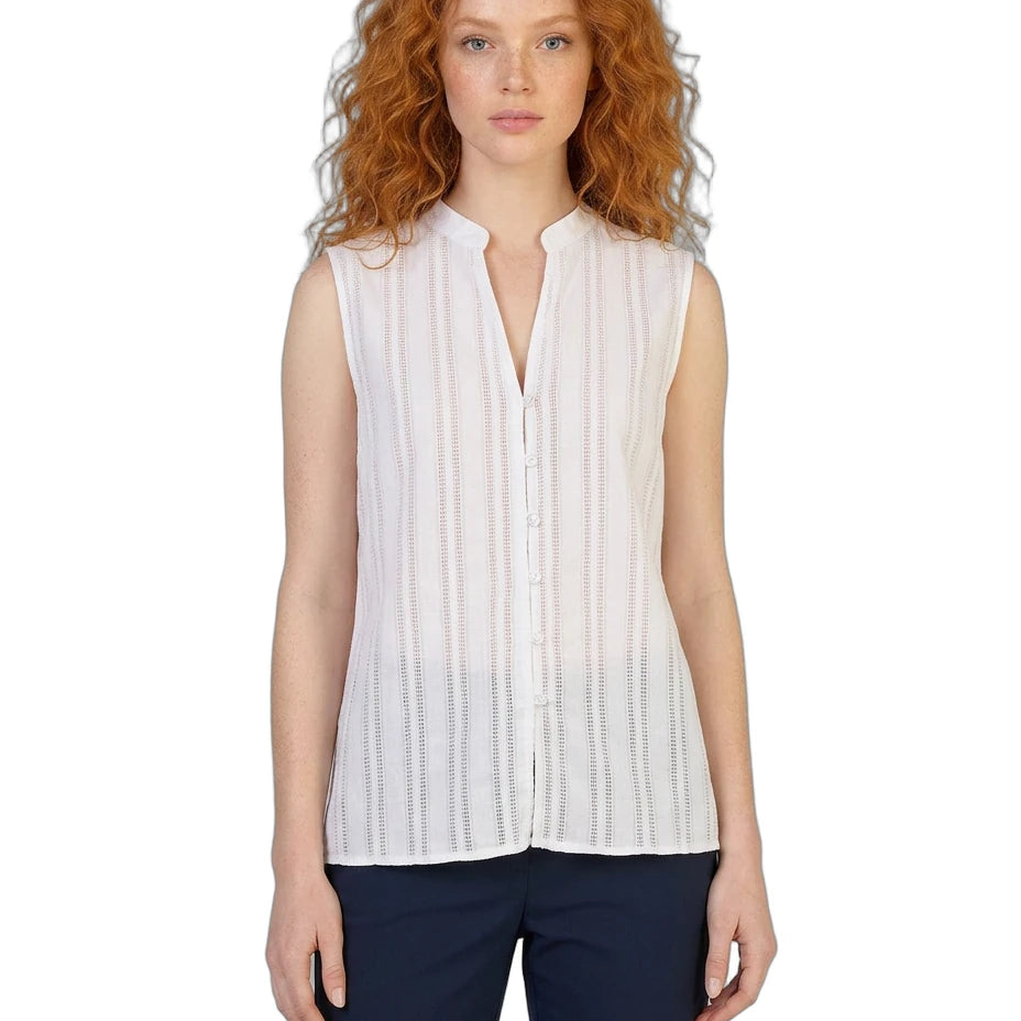 Woman wearing a white sleeveless Calvin Klein blouse with a plain background